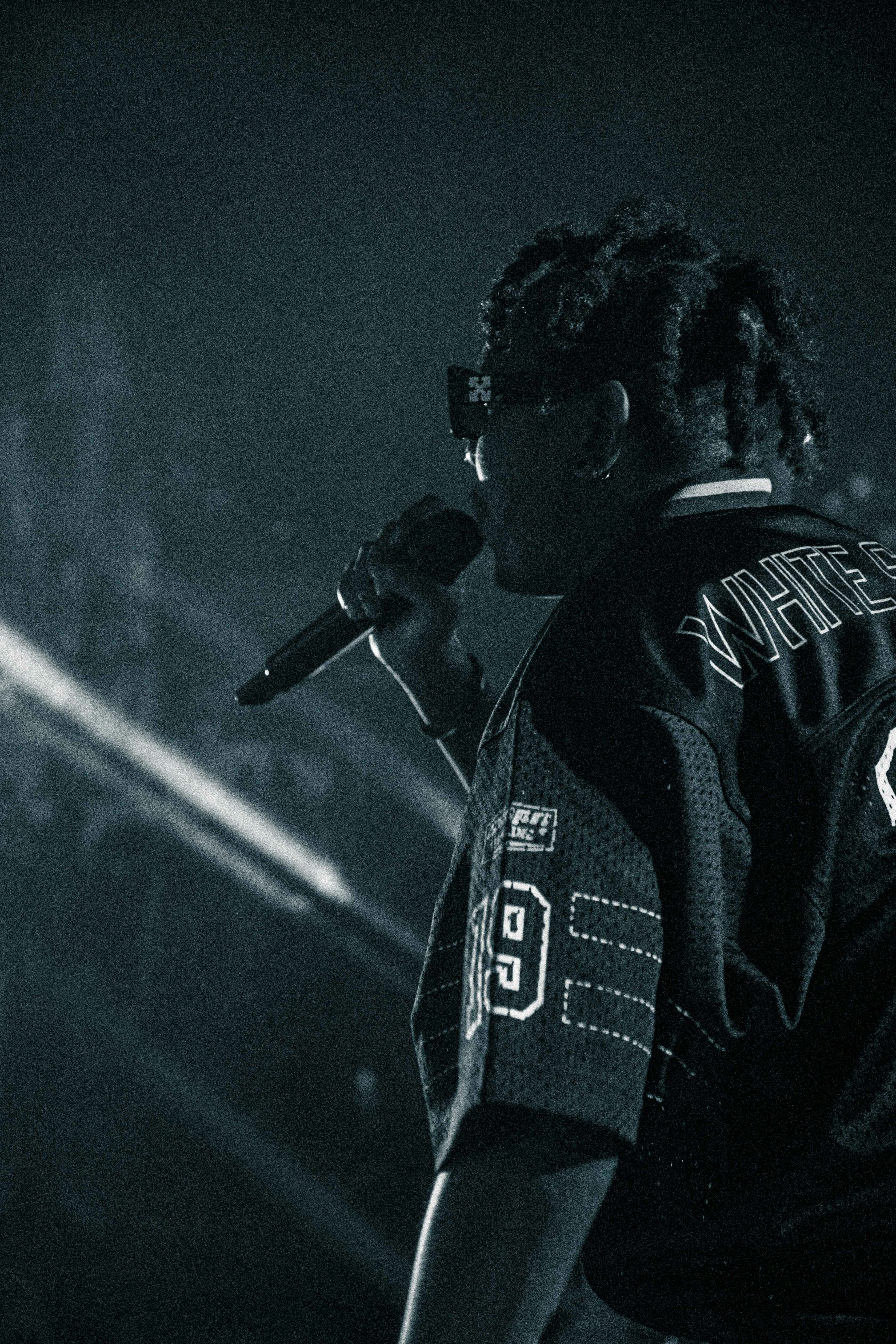 a man with dreadlocks holding a microphone